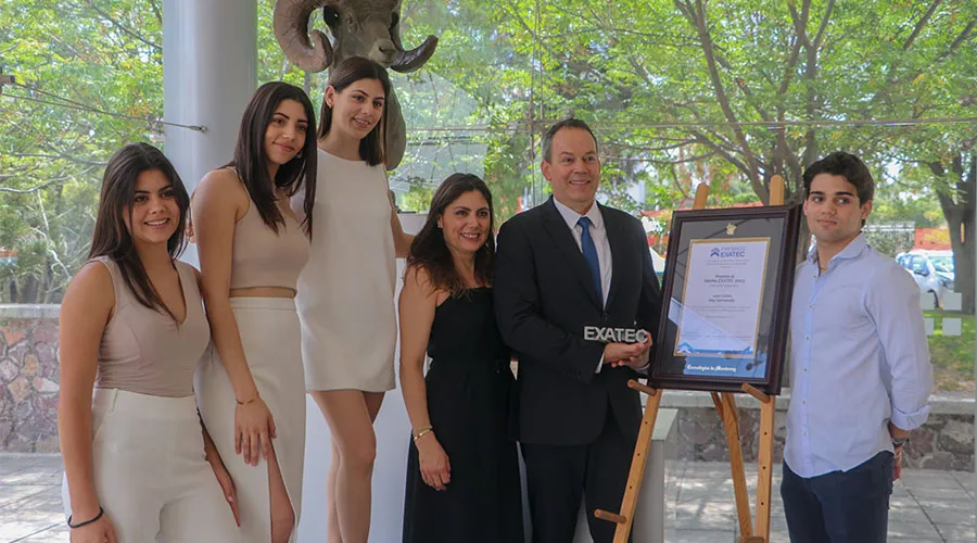 Juan Carlos y su familia posando con su placa de reconocimiento