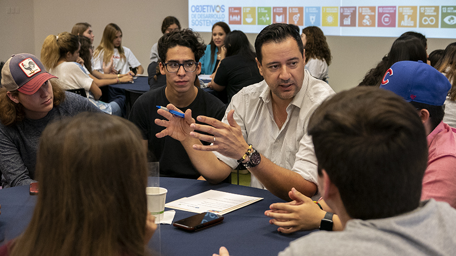 mentor con alumnos en mesa de dialogo