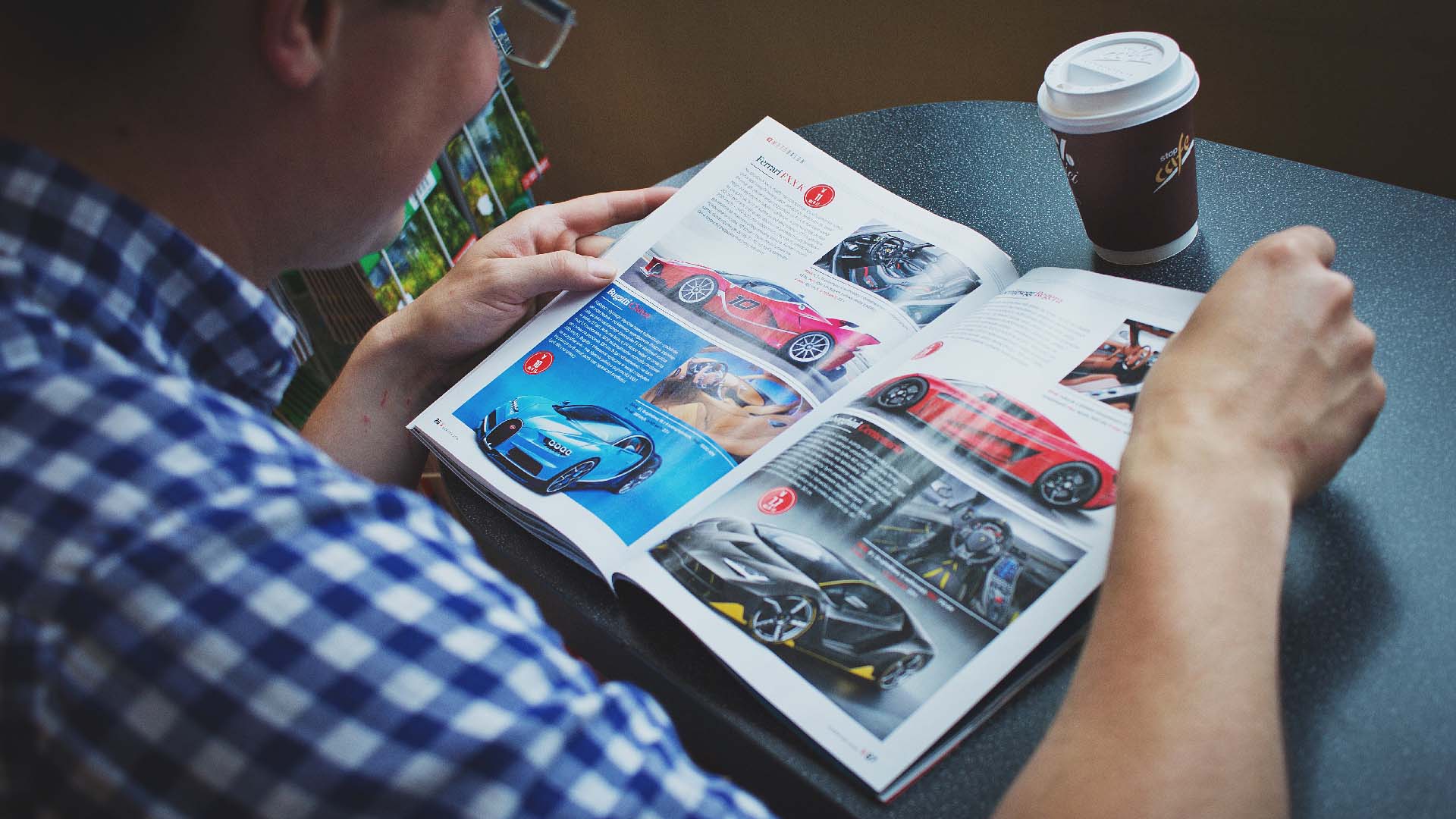 persona leyendo revista autos