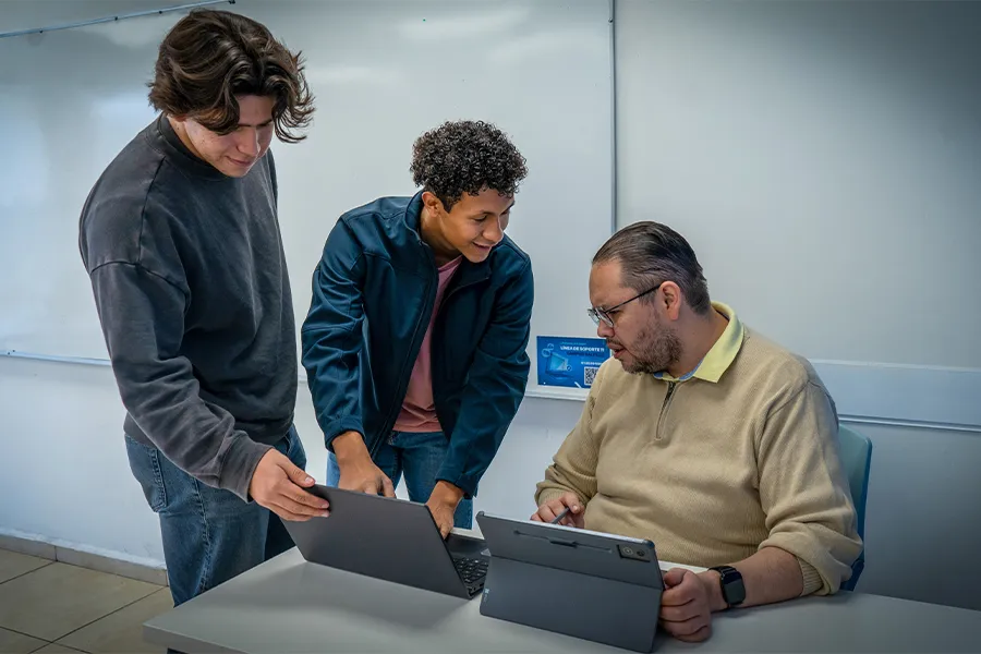 Estudiantes en asesor&iacute;a uno a uno con maestro.