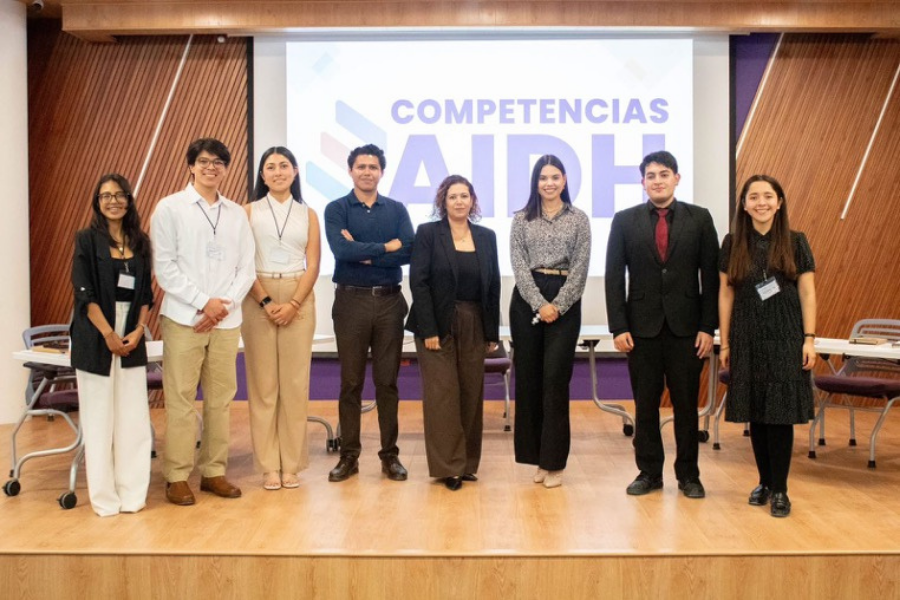 Milka y Luis junto a otros acad&eacute;micos durante la competencia de debate.