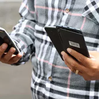 Hombre enseña los celulares que va a depositar en Reciclatec.