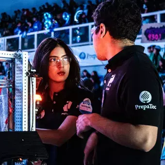 Jugador y jugadora alistan estrategia con su robot a un lado en el FIRST Regional Laguna 2025